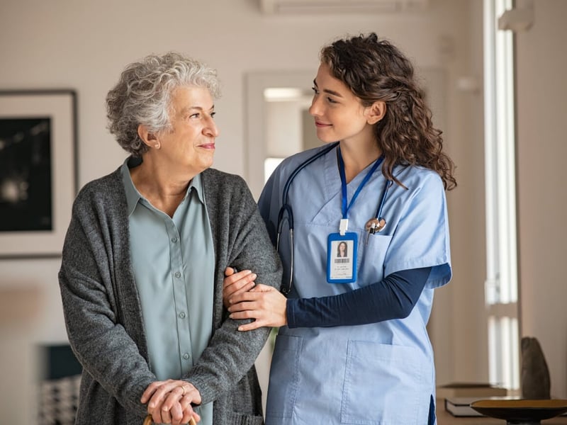 Nurse walking side by side with woman patient